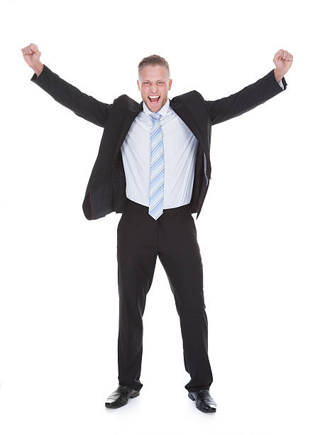 istock Young businessman in a suit standing cheering 516140817