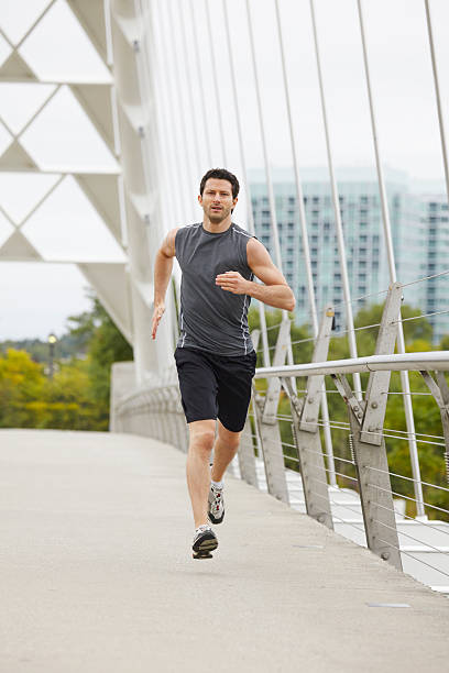 istock Man jogging on the bridge in the city 516140913