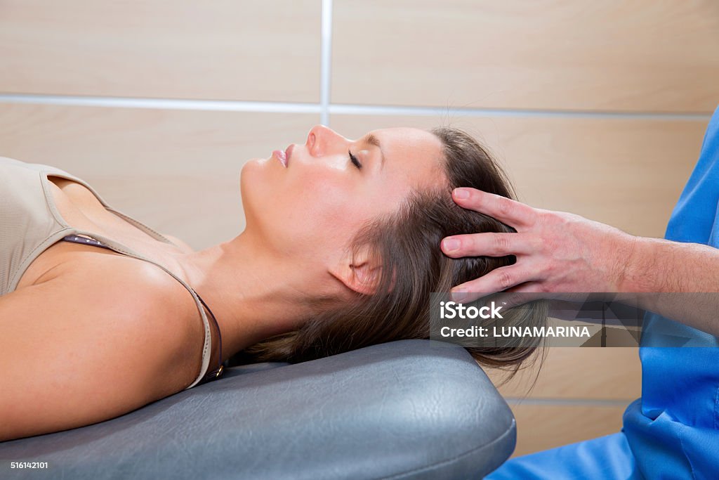 Massage therapy on cranial hear area by therapist Massage therapy on cranial hear area by therapist to a beautiful woman Human Skull Stock Photo