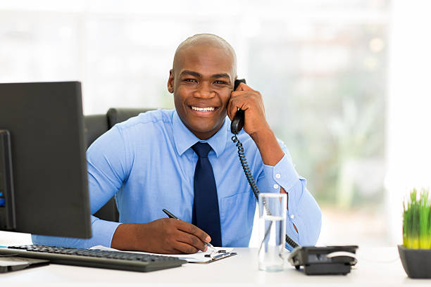 istock male african office worker talking on phone 516143005