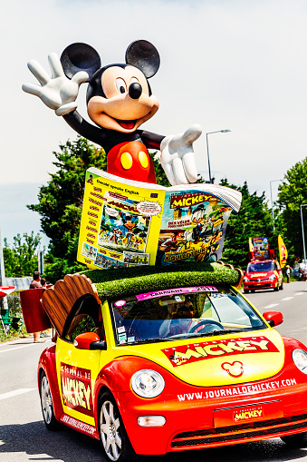 Saint Remy de Provence, France - July 20, 2014: Mickey Mouse car as part of the Tour de France caravan at Saint Remy de Provence during the 2014 cycle race. The car is an advert for 