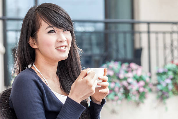 istock Young asian woman drinking coffee 516143561
