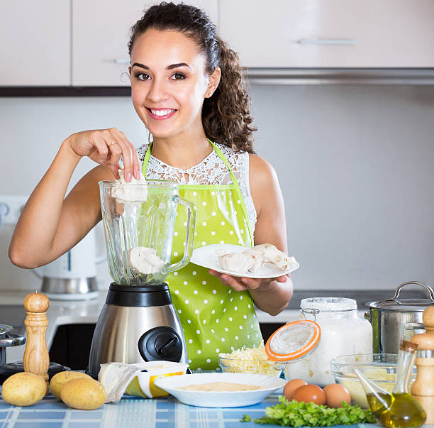 istock Cheerful girl grinding pate ingredients 516143734