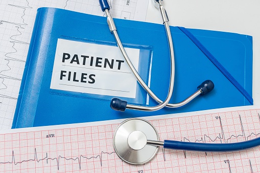 Blue folder with patient reports and files.
