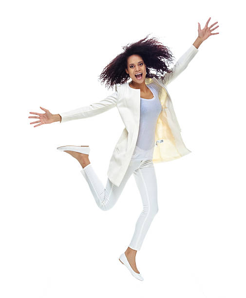 istock Cheerful  woman jumping with arms outstretched 516145054