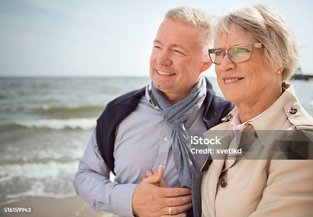 Senior Couple By The Sea Stock Photo - Download Image Now - 60-69 Years, Active Lifestyle, Active Seniors