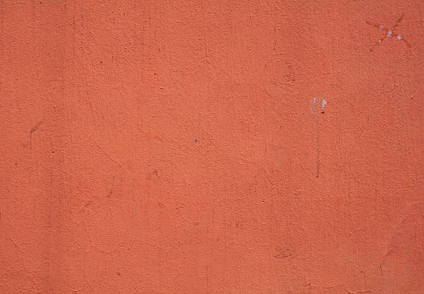istock Texture of wall covered orange stucco relief 516162897
