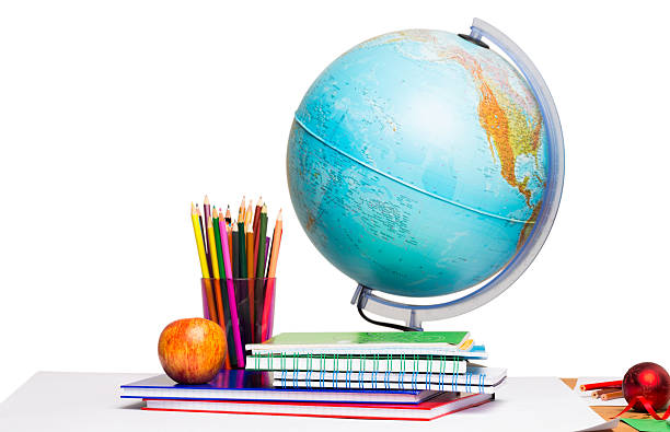 istock Pupils desk with books and globe 516163307