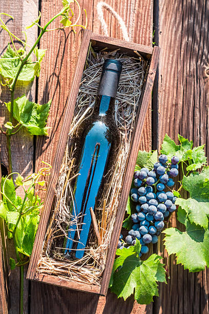 istock Red wine in a wooden box with hay 516164295