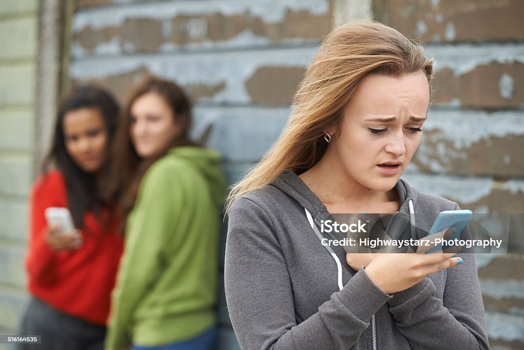 Teenage Girl Being Bullied By Text Message People Stock Photo