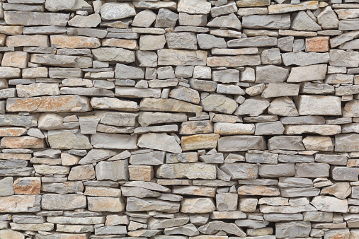 Stone wall background, traditional construction way