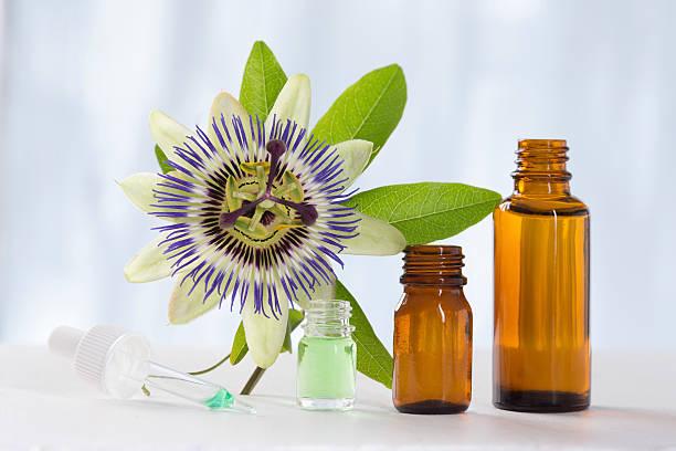 Passion flower with aromatherapy essential oil brown glass bottl stock photo