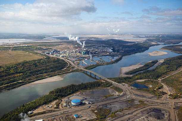 Oil Refinery A large oil refinery along the Athabasca River in Alberta's Oilsands.  Fort McMurray, Alberta. oilsands stock pictures, royalty-free photos & images