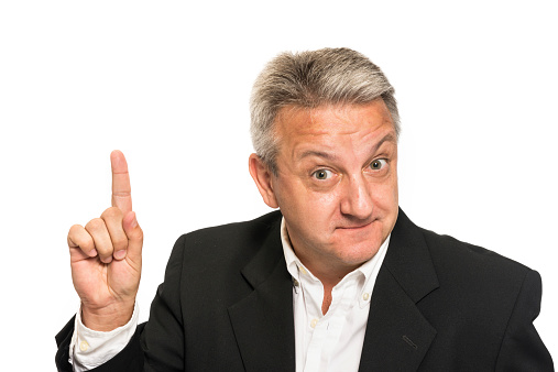 Mature man posing pointing up on white background