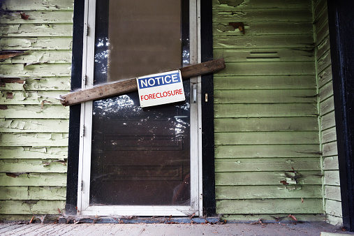 Old house with Foreclosure sign on the door