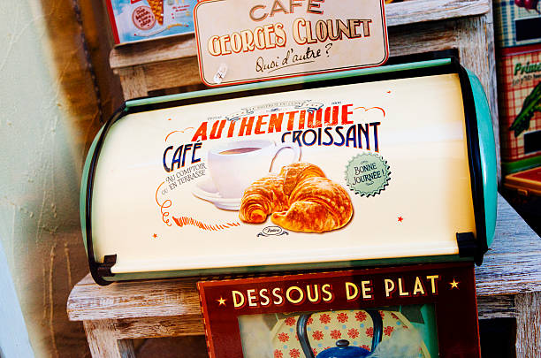 Saint Remy de Provence, France - July 14, 2014: Bread bin and other retro style goods for sale outside a shop on the corner of Rue Carnot and Rue de Chateau in Saint Remy de Provence in France. The Provencal town is very popular with tourists, not only attracted by the sunny weather, but also in browsing through the many small shops hidden amongst the picturesque alleyways. The  Cafe Georges Clounet sign is an allusion to the famous Hollywood actor.