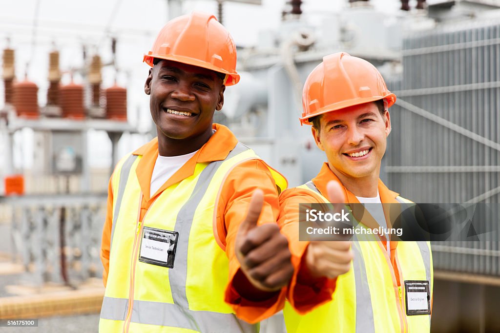 electricians giving thumb up in substation handsome electricians giving thumb up in substation Adult Stock Photo