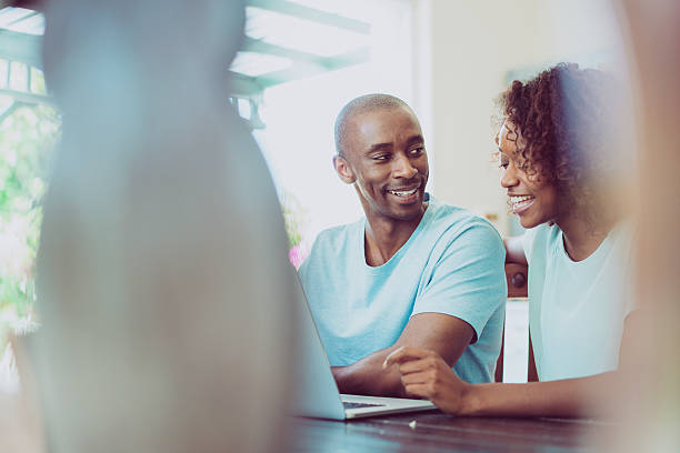 istock Happy couple using laptop at home 516177092