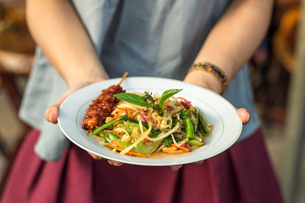 Khmer green papaya salad "bok lahong" Bok lahong - Khmer spicy papaya salad is popular salad in Phnom Penh, Cambodia. khmer stock pictures, royalty-free photos & images