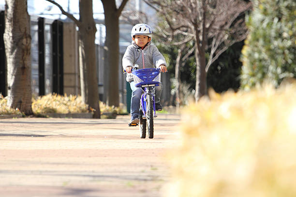 Child riding bicycle outdoor on sunny day