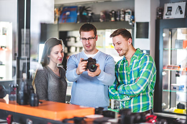 istock Sales person showing digital camera 516178174