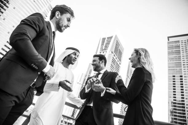 Monochrome image of business executives unwinding after work