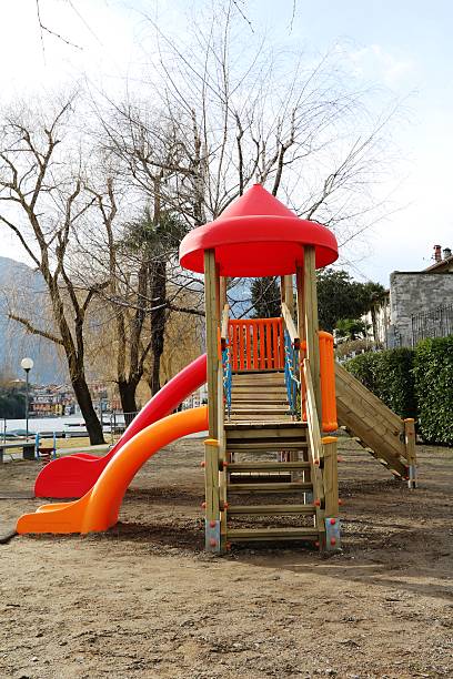 istock Children's Playground in a park at a lake 516180336