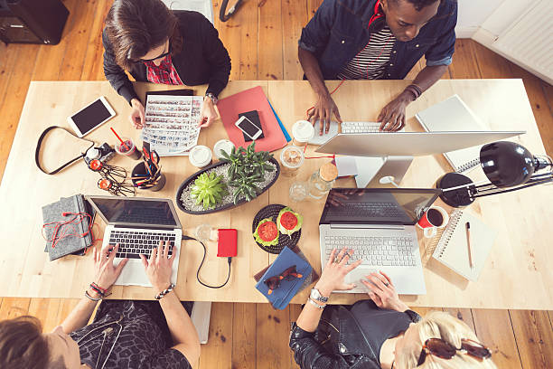 istock High angle view of creative people working at the table 516180816
