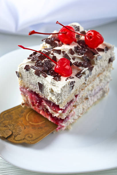 Homemade cake with cherries and chocolate on white plate