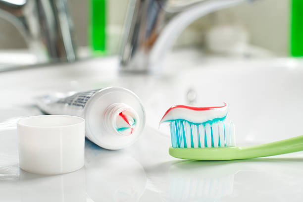 Toothbrush Toothbrush and toothpaste in the bathroom close up. toothpaste stock pictures, royalty-free photos & images