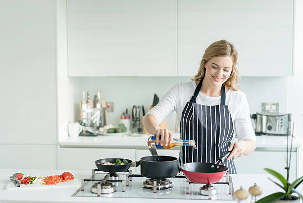 istock Happy woman cooking at home 516183744