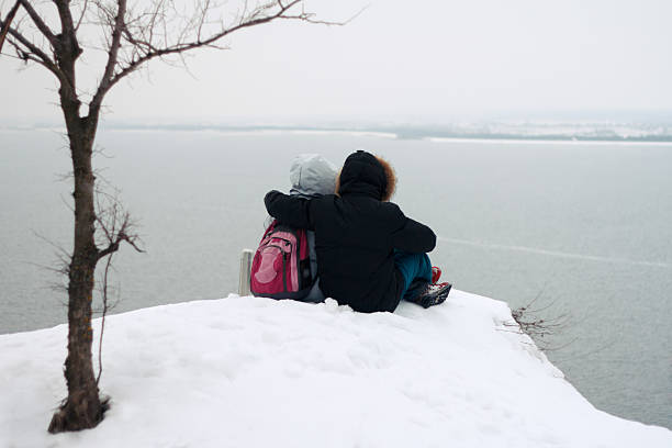 istock Pensive couple is resting on a hill in the winter 516183768