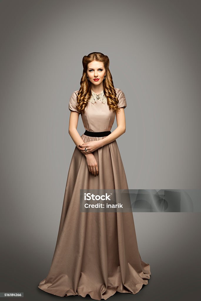Woman Long Dress, Fashion Model in Historical Gown, Gray Woman Long Dress, Fashion Model in Historical Gown over Gray Background Women Stock Photo