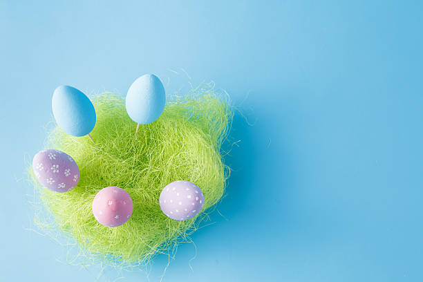 istock Springtime nest with colorful Easter Eggs against blue backgroun 516184436