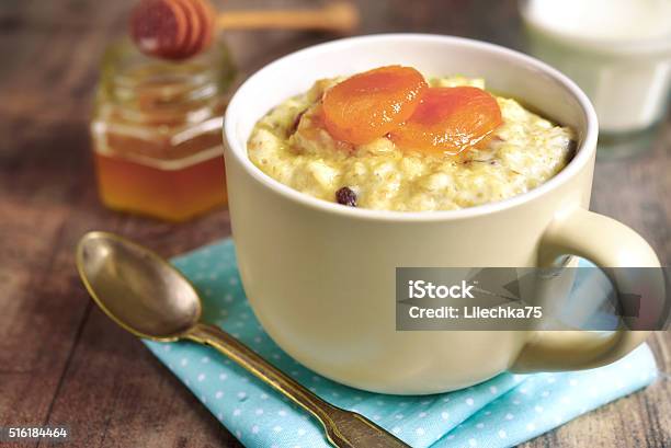 Oat Porridge With Honey Raisins And Dried Apricots Stock Photo - Download Image Now