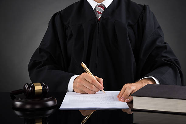 istock Judge Writing On Paper In Courtroom 516186782