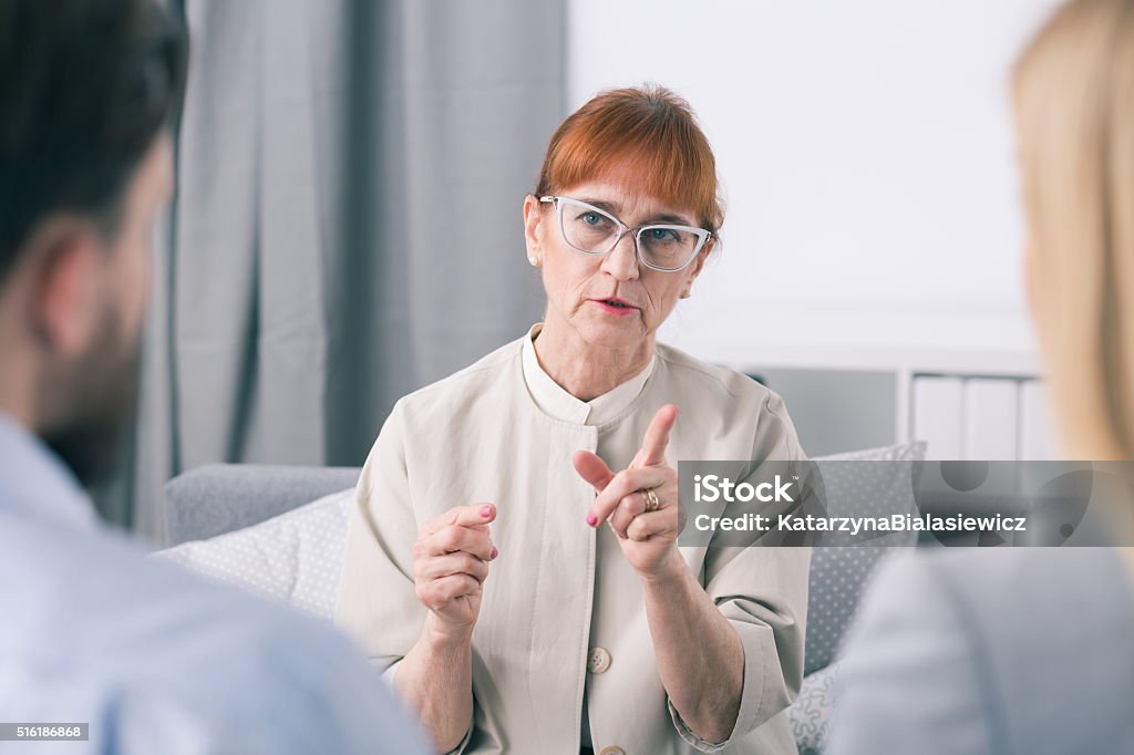 Listen, you can't fight with each other Mature marriage counselor and her patients Adult Stock Photo