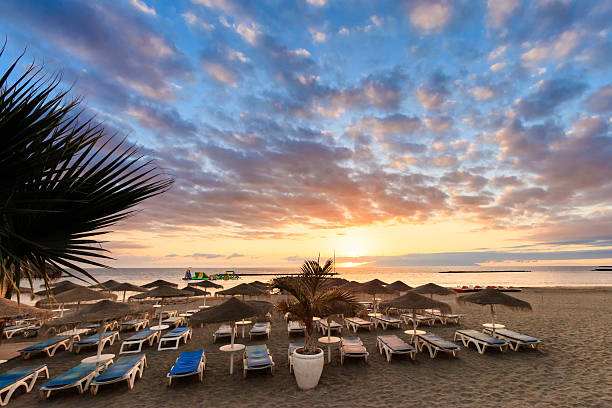 Summer sunset seascape on tropical island Tenerife, Canary in Spain. Costa Adeje view on La Gomera island from playa Fanabe beach.