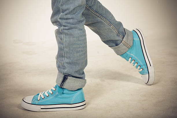 istock Boy in blue sneakers walking 516187927