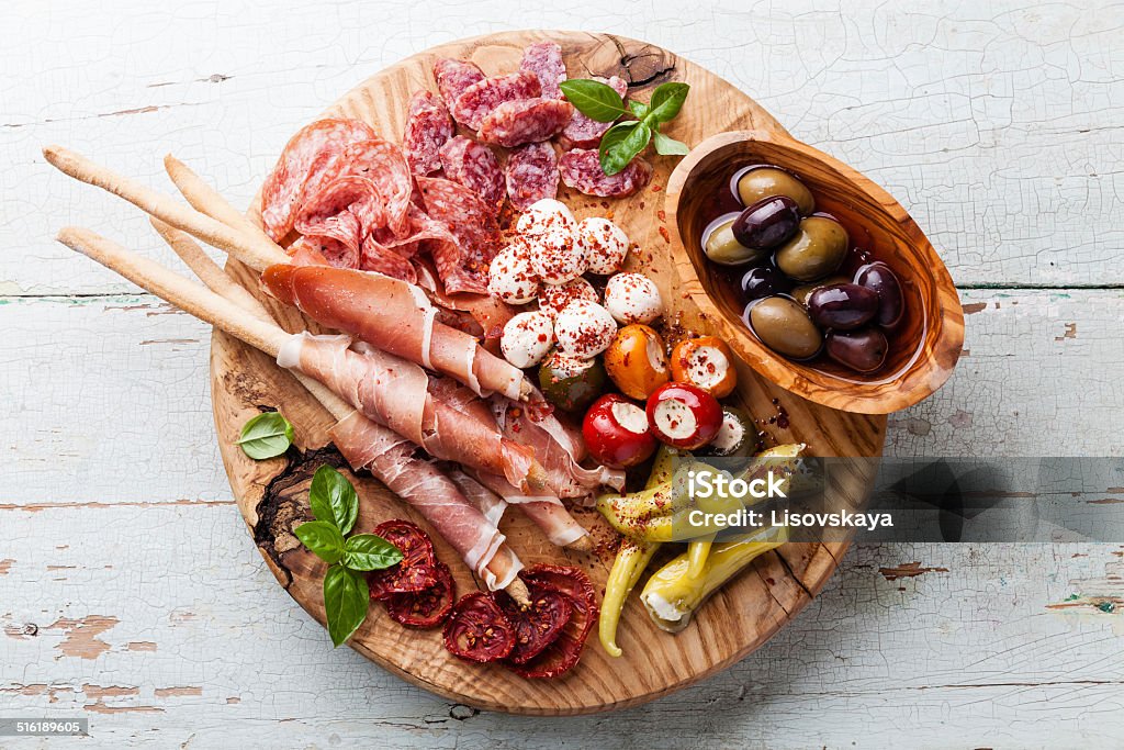 Cold meat plate and bread sticks Cold meat plate and grissini bread sticks on wooden background Italian Food Stock Photo