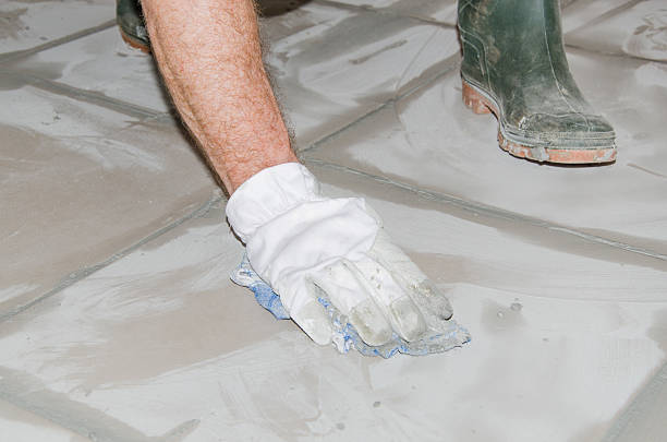istock Tiler cleaning tiles after filling up joints 516190065