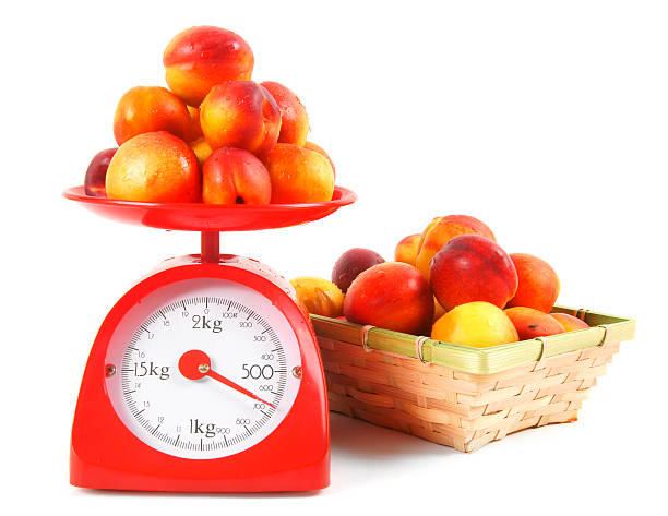 istock Apricots on scales and in a basket 516191527