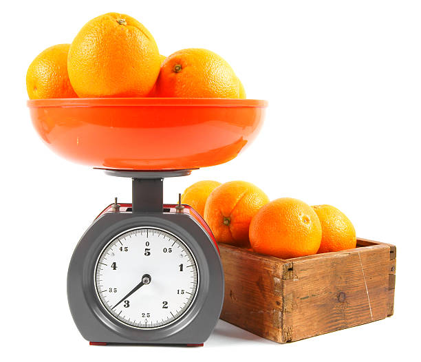 istock Oranges on scales and in a box 516191585