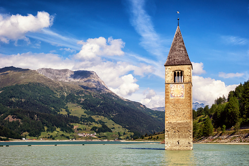 famous historic bell tower at the reschenpass - italy