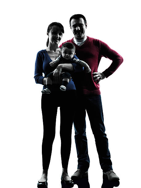 istock parents standing  with baby silhouette 516193649