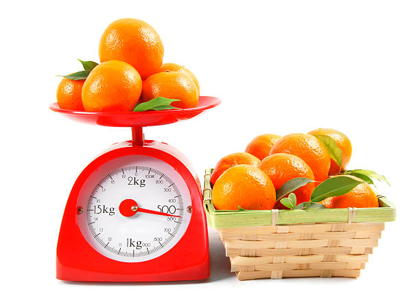 istock Tangerines on scales and in a basket 516195703