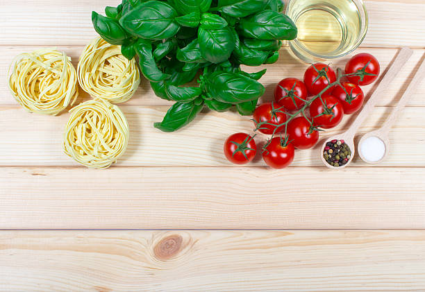 Raw homemade pasta, ingredients for pasta with tomatoes and basil.