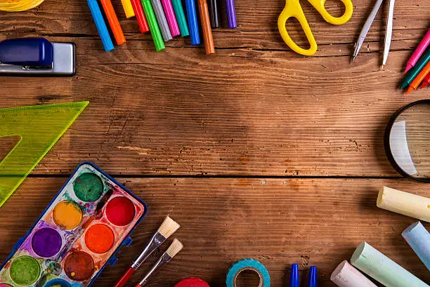 Photo of Desk with school supplies against wooden background, copy space