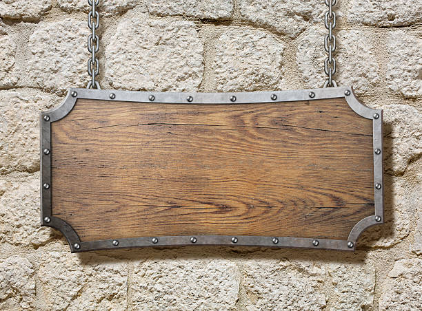 istock wood sign with metal frame on old stone wall 516207430