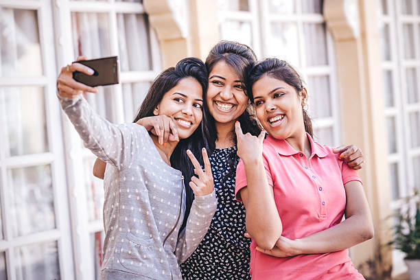istock Young Indian Female Friends taking a selfie 516207564
